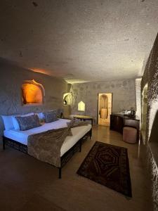 a bedroom with a large bed in a room at Ortahisar Cave Hotel in Ortahisar