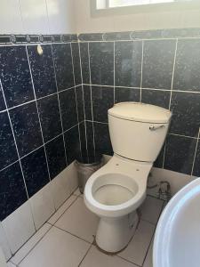 a bathroom with a toilet and a sink at Shiloh Shared in Gaborone