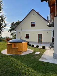 a house with a hot tub in the yard at Sweet Retreat in Trebelno
