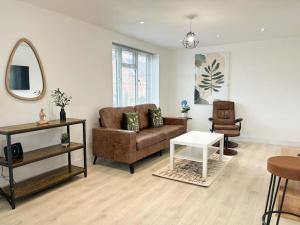 a living room with a couch and a table at Shrewsbury Townhouse in Harlescott