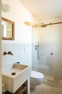 a bathroom with a sink and a toilet and a shower at Trullo Jalè - Boutique Apartments in Ostuni +88 photos