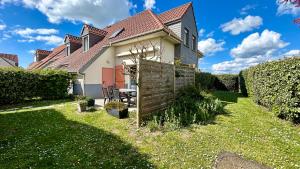 a house with a wooden fence in the yard at La Bignone - Charmante maison pour 6 personnes à Le Crotoy in Le Crotoy