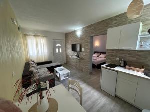 a living room with a kitchen and a bedroom at Green Field Apartments in Virpazar