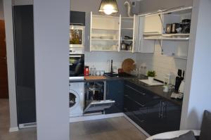 a kitchen with a washer and a washing machine at Apartament DeLuxe 4 in Oświęcim +19 photos