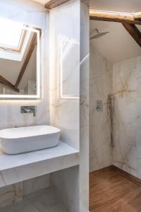 a bathroom with a sink and a mirror at FLOARA DI MUNTE Forest Luxury Suites in Metsovo