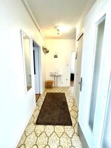 a hallway with a white door and a rug at Apartment Kontrada in Umag