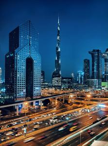 a city skyline at night with traffic on a freeway at Dusit Thani Dubai in Dubai