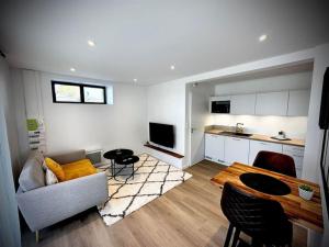 - un salon avec un canapé et une table dans l'établissement Berder - T2 - 10 min gare - terrasse - parking - linge inclus, à Vannes