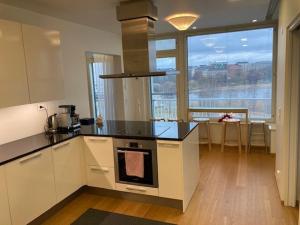 a kitchen with a counter and a large window at Alvar 114 in Helsinki