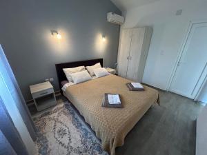 a bedroom with a bed with two plates on it at Green Field Apartments in Virpazar