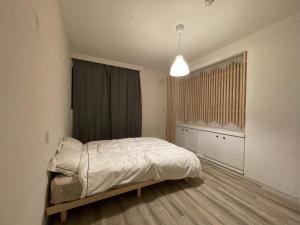 a bedroom with a bed and a pendant light at &HouSE - Vacation STAY 93911v in Takagi