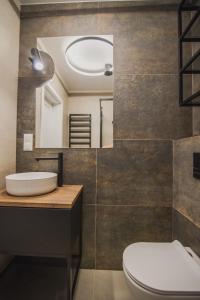 a bathroom with a sink and a mirror at Dom Goscinny Bialy Dworek in Człuch&oacute;w