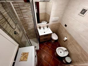 a small bathroom with a toilet and a sink at Light House Bisceglie in Bisceglie +20 photos