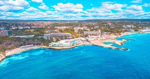 an aerial view of a city next to the ocean at Studios in Sveta Elena complex with mineral pool in St. St. Constantine and Helena