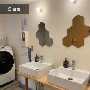 a bathroom with a sink and two mirrors on the wall at &HouSE - Vacation STAY 93911v in Takagi