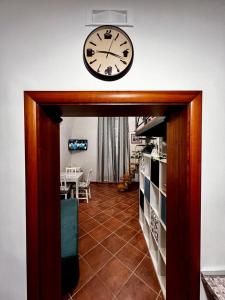 a clock on the wall above a room with a table at Light House Bisceglie in Bisceglie