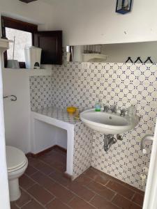 a bathroom with a sink and a toilet at Casa Lilian in Stromboli
