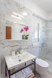 a white bathroom with a sink and a toilet at Apartments Marija Bibić in Hvar +94 photos