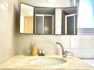 a bathroom with a sink and a mirror at Two Bedrooms Duplex Apartment l Bugrashov Street l by Bookiz in Tel Aviv +19 photos