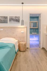 a bedroom with a bed and a bathroom with a sink at Patras Apartments in Fournoi +223 photos