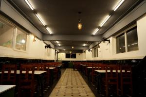 an empty dining room with tables and chairs at HILL PALACE RESIDENCY COORG in Virajpet
