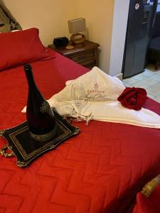 a bottle of wine and a glass on a bed at Hotel Boutique Castillo Ines Maria in Cartagena de Indias