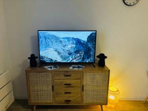 a flat screen tv sitting on top of a dresser at Studio calais la plage in Calais +7 photos