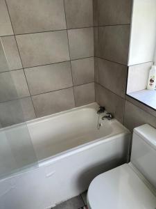 a bathroom with a white tub and a toilet at Iyanla HOuse in Middleton