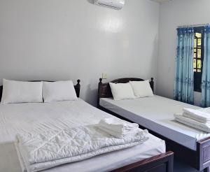 Tempat tidur dalam kamar di Cay Phuong Guesthouse