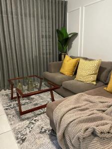 a living room with a couch and a coffee table at Lush Living The Blyde Riverwalk Estate Unit 101 in Pretoria