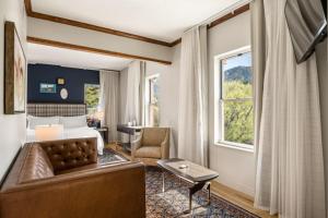 a hotel room with a bed and a couch at Hotel Maxwell Anderson in Glenwood Springs