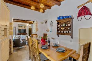 a kitchen and dining room with a wooden table at Cellar Villa in Xirosterni in Xirostérnion