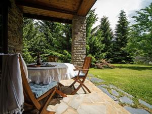 a patio with a table and chairs under a pavilion at Splendid house next to the Baqueira Beret ski resort in Vielha