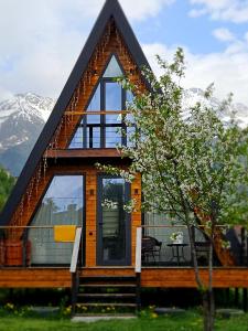 a house with a roof that has glass windows at B&B Cottage in Mestia in Mestia