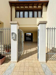 a gate leading into a house with a building at Casa Vacanze Chiara in Olbia