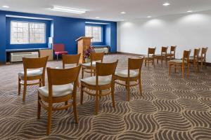 a waiting room with a row of chairs and a podium at Microtel Inn and Suites Dover in Dover