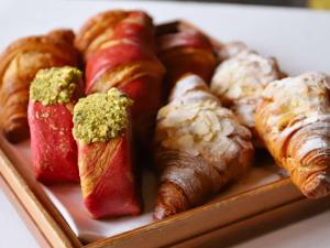 a tray of pastries and croissants and croissants and croiss at Sofitel Legend The Grand Amsterdam in Amsterdam