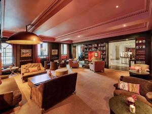 a large living room with couches and chairs at Sofitel Legend The Grand Amsterdam in Amsterdam