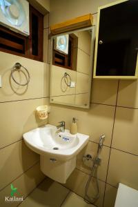a bathroom with a sink and a mirror at KAILANI BEACH RETREAT - Ayur Yoga Retreats in Nīleshwar +37 photos