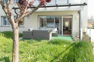 a house with sliding glass doors and a patio at Apartment mit Garten in Dobl-Zwaring