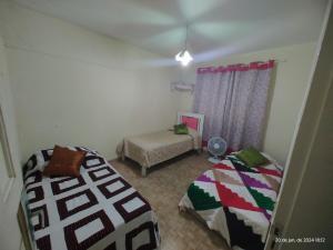 Ένα ή περισσότερα κρεβάτια σε δωμάτιο στο Aconchego famíliar