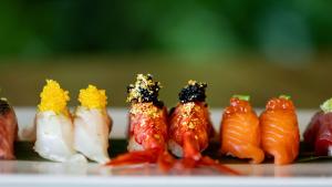 a row of different types of food on a plate at Conrad Algarve in Quinta do Lago