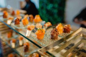 a bunch of food sitting on a glass tray at Conrad Algarve in Quinta do Lago