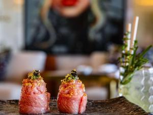two pieces of sushi sitting on a table at Conrad Algarve in Quinta do Lago