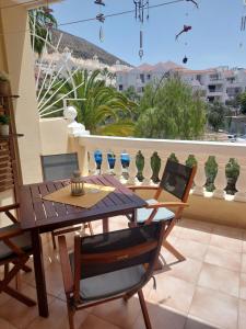 a dining room table with a laptop on a balcony at NICE 1 BEDROOM APARTMENT LOS CRISTIANOS in Los Cristianos