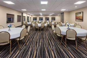 a conference room with white tables and chairs at Super 8 by Wyndham Copley Akron in Copley