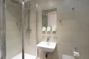 a bathroom with a sink and a shower at Hyde Park Boutique Hotel in London