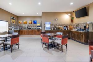 a restaurant with tables and chairs and a counter at Comfort Inn Grain Valley in Grain Valley