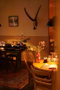 a dining room with a table with a vase of flowers at Cresta Palace Celerina in Celerina