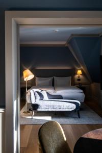 a bedroom with a bed and a blue wall at Cresta Palace Celerina in Celerina +37 photos